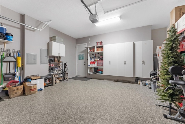 garage with electric panel and a garage door opener