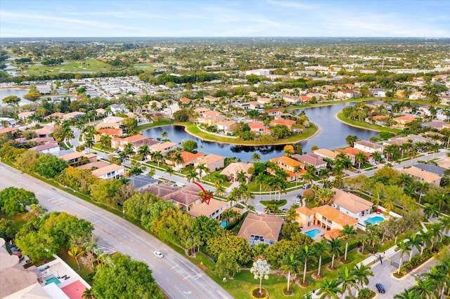 drone / aerial view featuring a residential view and a water view