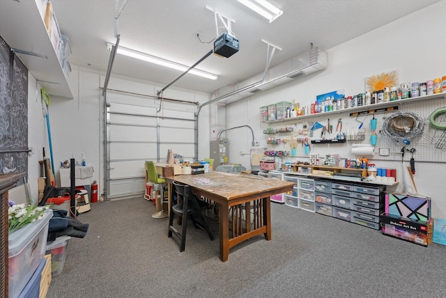 garage with a workshop area and a garage door opener