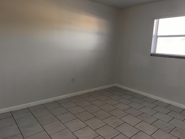 spare room featuring baseboards