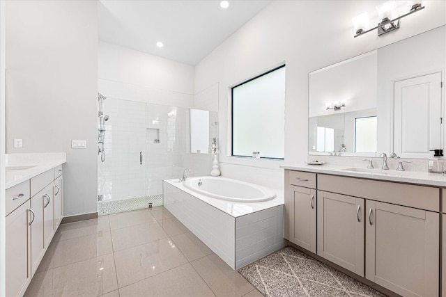 bathroom featuring two vanities, a sink, tile patterned flooring, a shower stall, and a bath