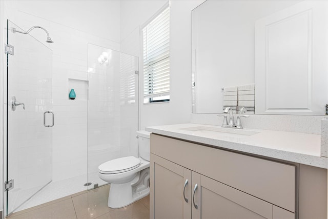 bathroom featuring toilet, a stall shower, tile patterned floors, and vanity