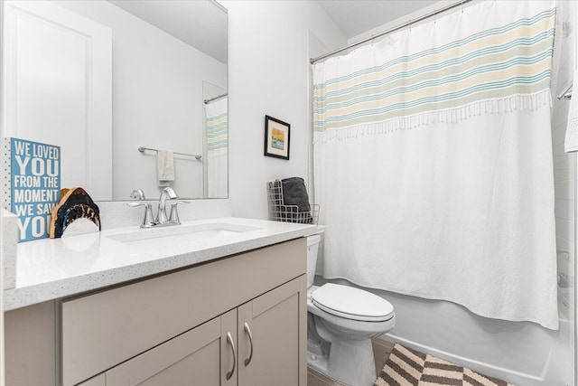 bathroom with vanity, toilet, and shower / bath combo with shower curtain