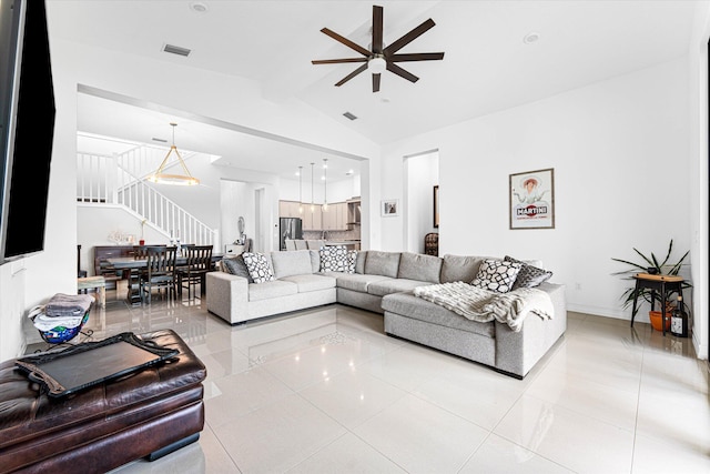 living room with vaulted ceiling with beams, light tile patterned flooring, a ceiling fan, baseboards, and stairway