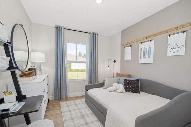 bedroom with baseboards and light wood-style floors