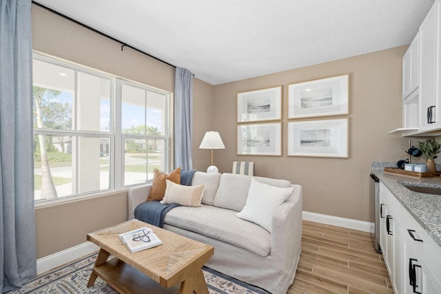 living room with baseboards and wood finish floors