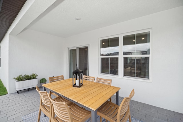 view of patio / terrace with outdoor dining area and radiator heating unit