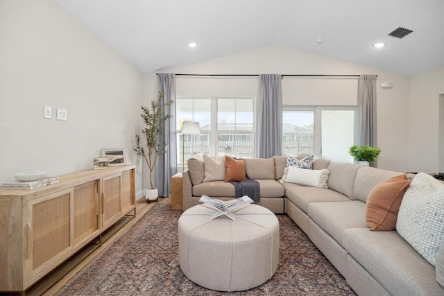 living area with visible vents, recessed lighting, lofted ceiling, and wood finished floors