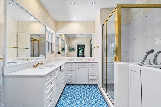 full bath featuring a tub, vanity, a shower stall, and wallpapered walls