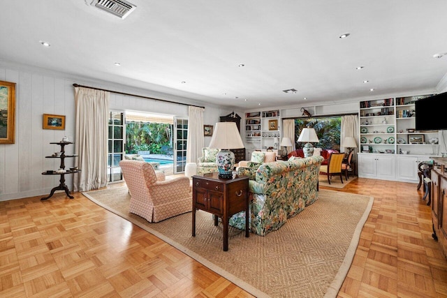 living room featuring visible vents, recessed lighting, and built in features