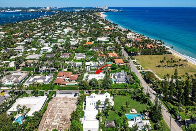 birds eye view of property featuring a beach view and a water view