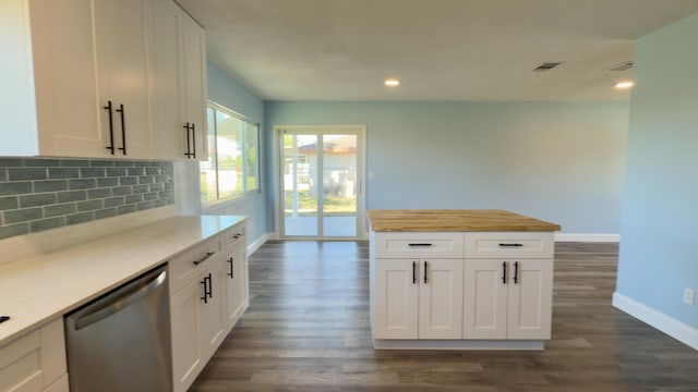 kitchen with tasteful backsplash, visible vents, dark wood-type flooring, dishwasher, and baseboards