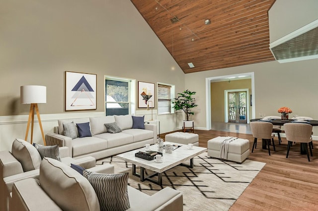 living room with light wood finished floors, high vaulted ceiling, and wood ceiling