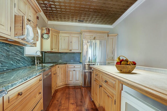 kitchen featuring appliances with stainless steel finishes, an ornate ceiling, and ornamental molding