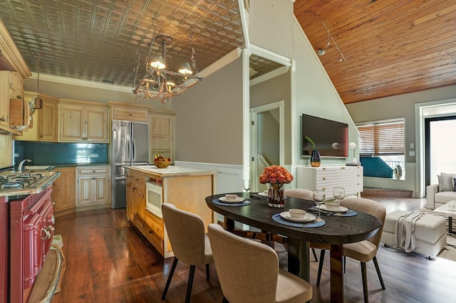 kitchen featuring white microwave, freestanding refrigerator, dark wood-style floors, a notable chandelier, and an ornate ceiling