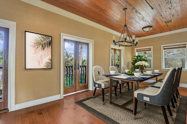 dining area featuring visible vents, french doors, crown molding, and wood finished floors