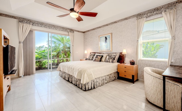 bedroom with wallpapered walls, ceiling fan, and access to outside