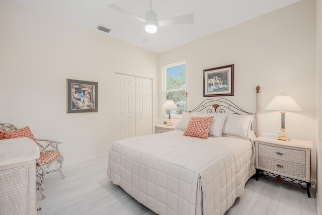 bedroom with visible vents, baseboards, light wood-style flooring, a closet, and a ceiling fan