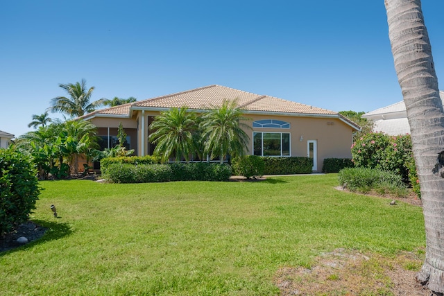 exterior space featuring a yard, stucco siding, and a tiled roof