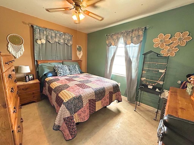 bedroom with a ceiling fan and baseboards