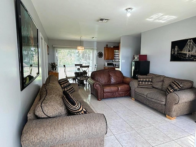 living area with visible vents and light tile patterned flooring