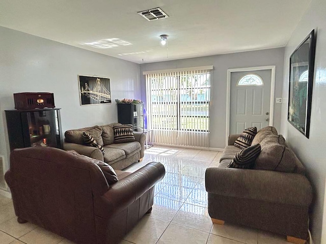 living room featuring visible vents and light tile patterned floors