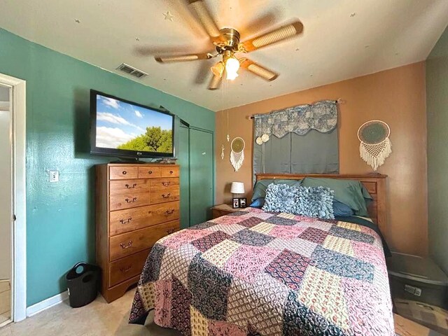 bedroom with ceiling fan, light carpet, and visible vents