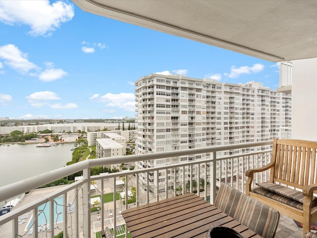 balcony with a water view and a city view