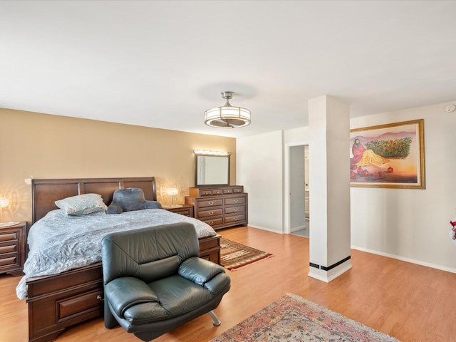 bedroom featuring light wood-type flooring and baseboards