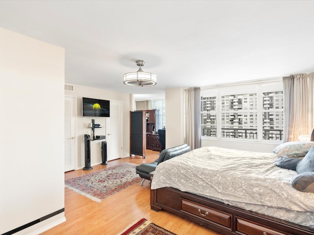 bedroom featuring visible vents and light wood-style flooring