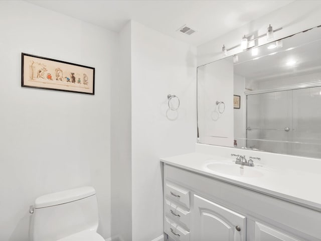 bathroom with toilet, a shower with door, visible vents, and vanity