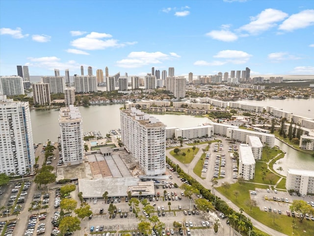 birds eye view of property with a water view and a city view