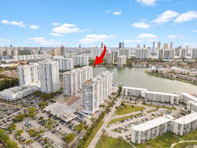 drone / aerial view featuring a view of city and a water view