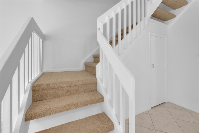 stairs with tile patterned flooring and baseboards