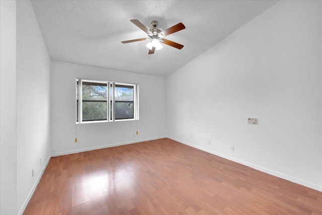 empty room featuring baseboards, a textured ceiling, wood finished floors, and a ceiling fan