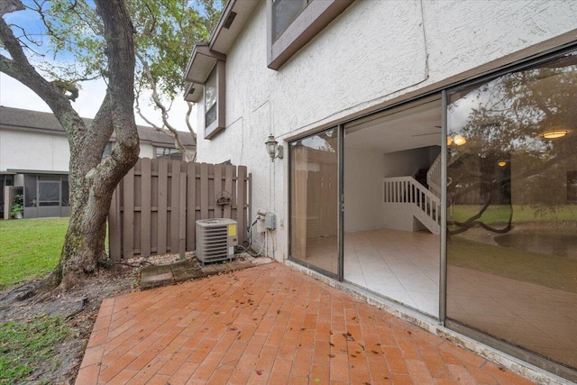 view of patio / terrace featuring cooling unit and fence