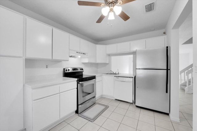 kitchen with visible vents, under cabinet range hood, a sink, appliances with stainless steel finishes, and light countertops