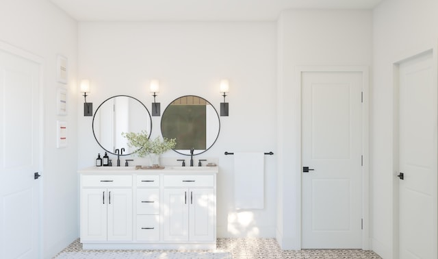 bathroom featuring double vanity, speckled floor, and a sink