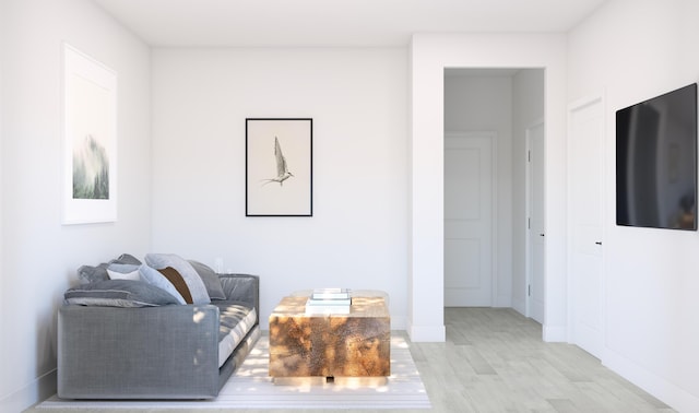 living area featuring light wood-style floors and baseboards