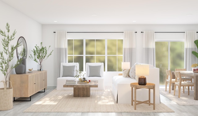 living area featuring plenty of natural light, wood finished floors, and recessed lighting