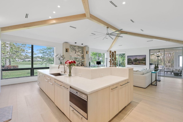 kitchen featuring light wood-style floors, modern cabinets, visible vents, and a sink