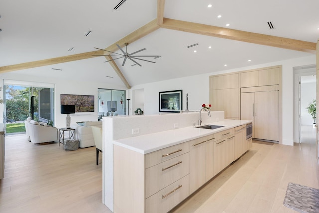 kitchen with paneled built in refrigerator, open floor plan, modern cabinets, and a sink