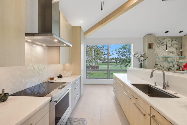 kitchen with electric stove, backsplash, a sink, modern cabinets, and wall chimney exhaust hood