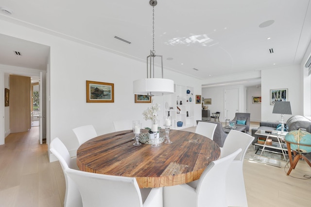 dining room with light wood-style flooring and visible vents