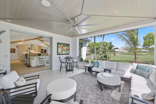 sunroom / solarium featuring wooden ceiling and a ceiling fan