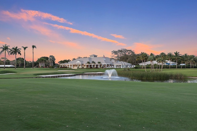 view of property's community featuring a water view and a yard