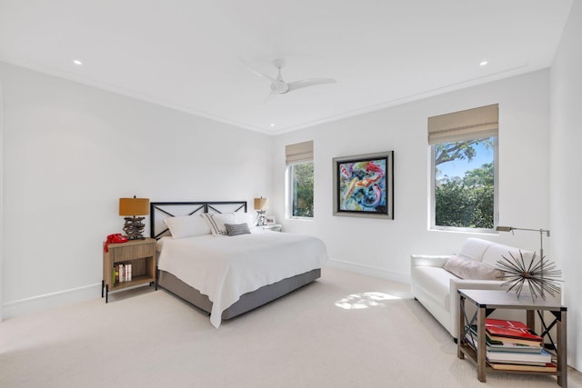 bedroom with a ceiling fan, light colored carpet, crown molding, and baseboards