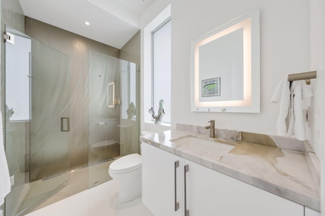 full bathroom featuring toilet, a stall shower, tile patterned flooring, and vanity