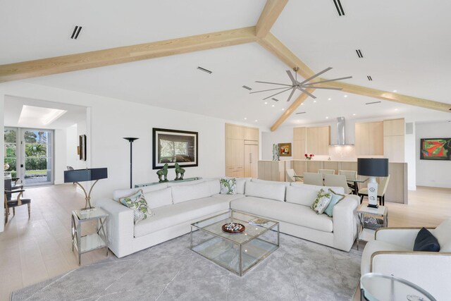 living area featuring lofted ceiling with beams, light wood-style flooring, and recessed lighting