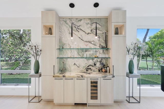 bar featuring wine cooler, backsplash, a wealth of natural light, and wet bar